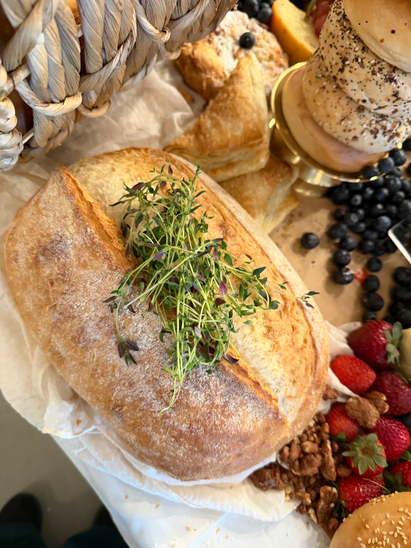 Artisan bread and pastry basket with fresh microgreens