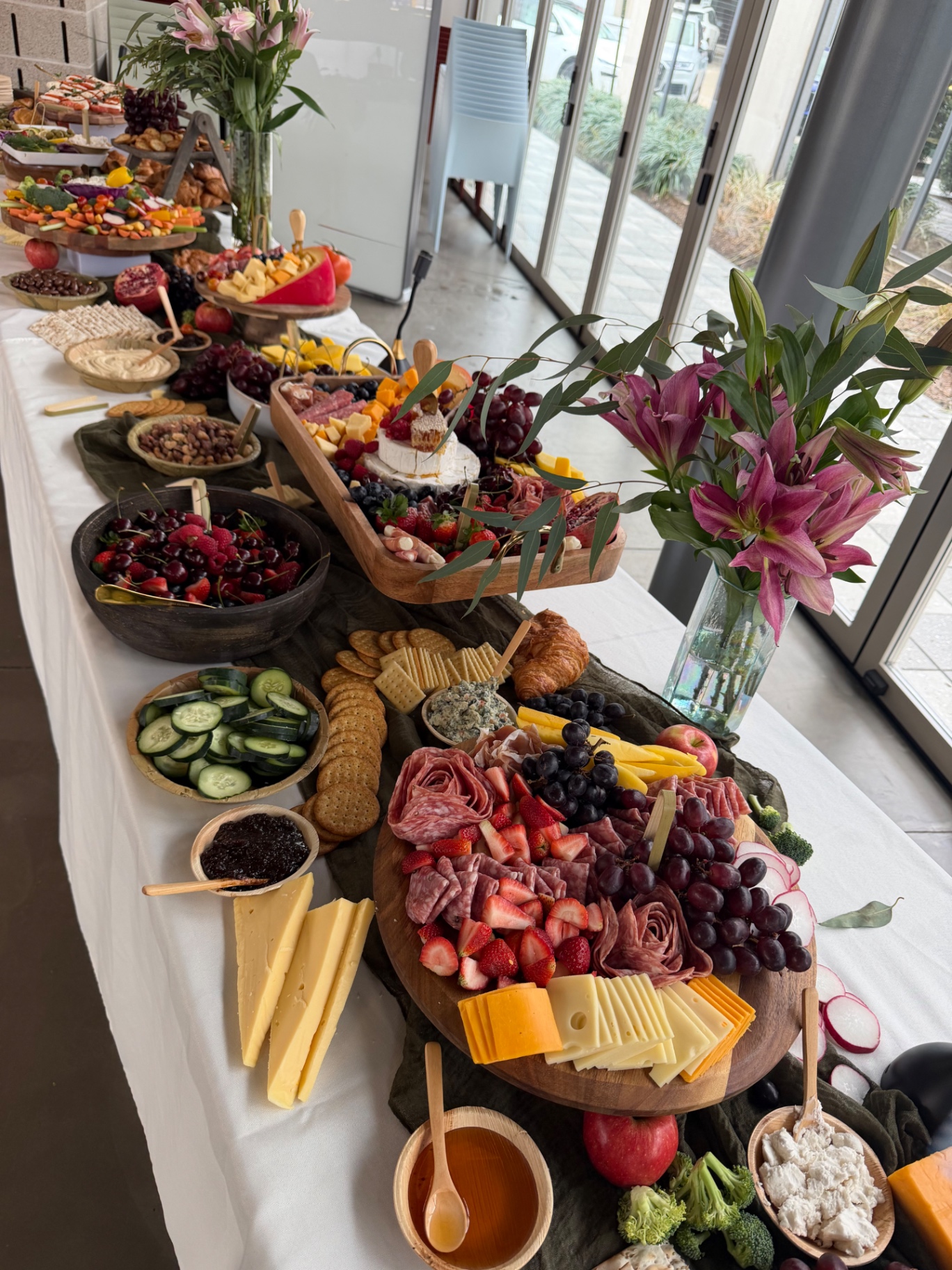 Full-length grazing table with charcuterie, fruit and florals