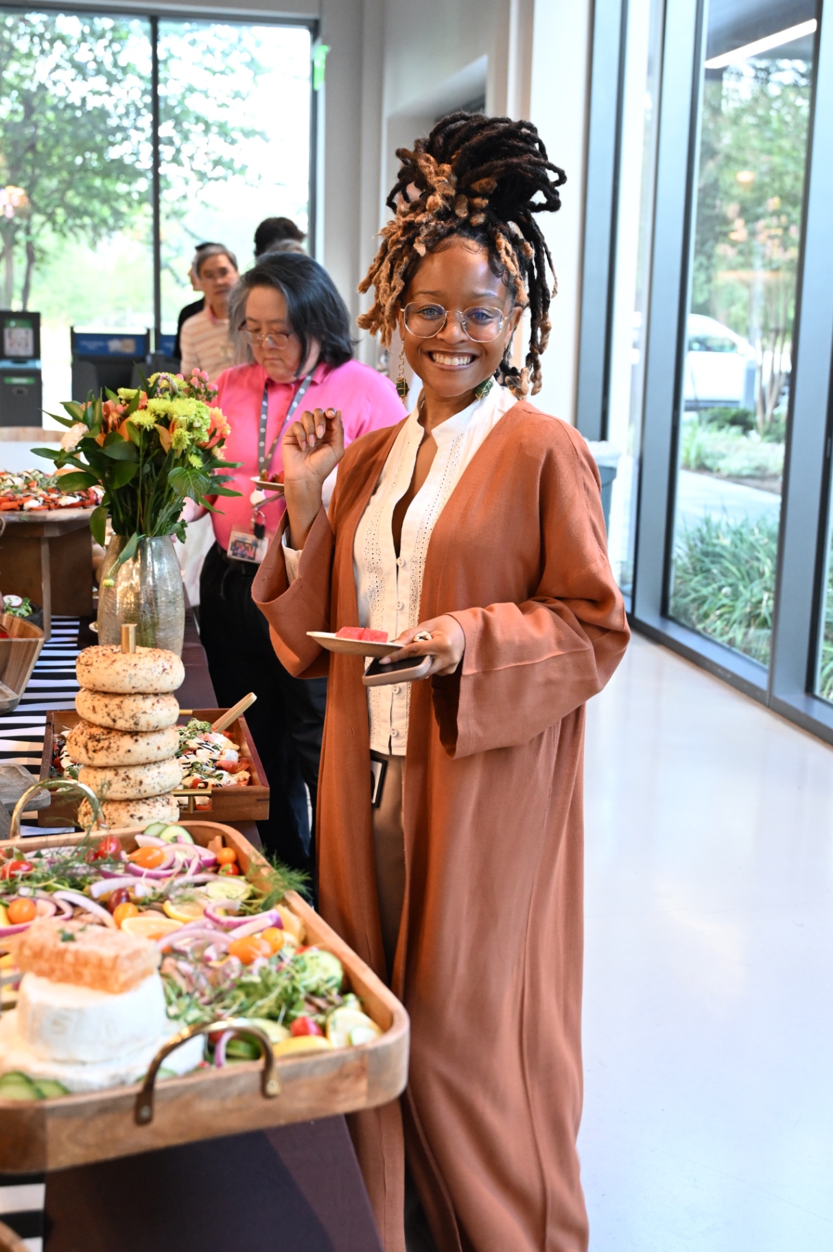 Brionna smiling beside a corporate grazing spread
