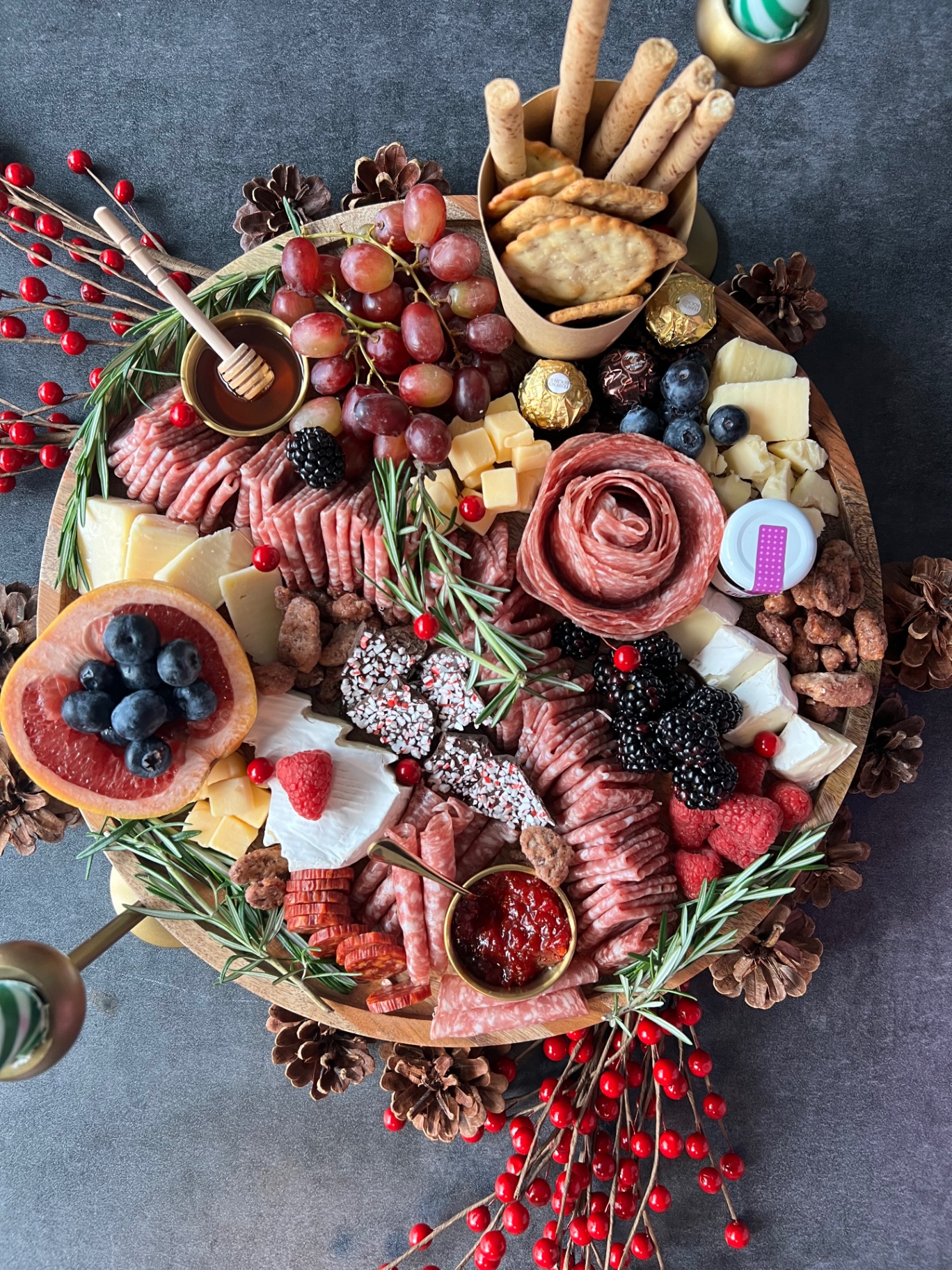 Holiday charcuterie board with salami roses, brie and rosemary